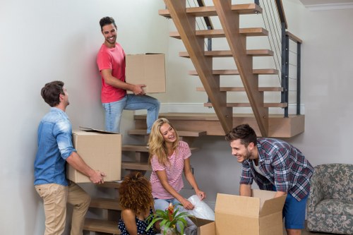 Removal team handling boxes and furniture in a Blackfriars apartment move