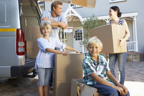 Movers carrying furniture through a central London apartment building